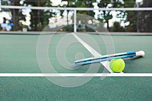 Tennis racket and ball on the court
