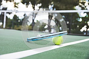 Tennis racket and ball on the court