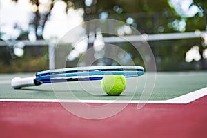 Tennis racket and ball on the court