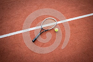 Tennis racket and ball on court