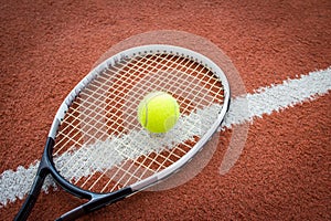 Tennis racket and ball on court