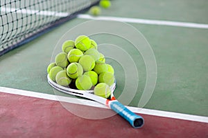 Tennis racket and ball on court after game