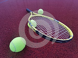tennis racket with a tennis ball on a tennis court photo