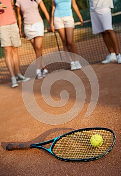 Tennis racket and ball on hard court