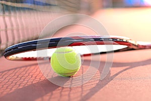 Tennis racket and the ball on tennis court