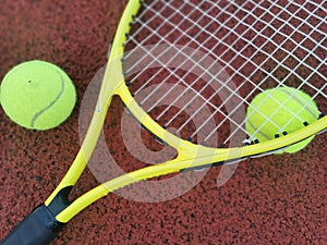 tennis racket with a tennis ball on a tennis court photo