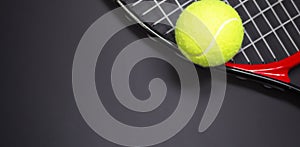 Tennis racket with tennis balls in green color, isolated on black background, lighting detail sport concept