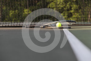 Tennis rackets and ball by net