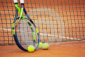 Tennis rackets and balls leaned against the net