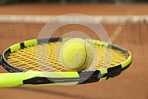 Tennis racquet tennis ball against clay court