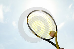 Tennis racquet tennis ball against sky background