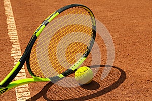 Tennis racquet and tennis ball clay court