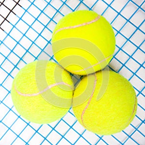 Tennis raquet with a tennis balls photo