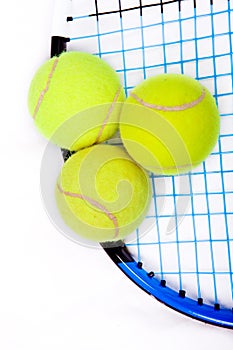 Tennis raquet with a tennis balls photo