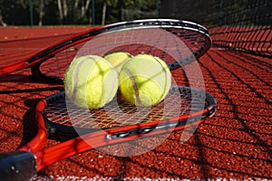 Tennis scene with black net, balls and racquet