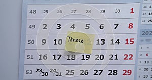 Tennis schedule. Man set remind sign in calendar with tennis traning.