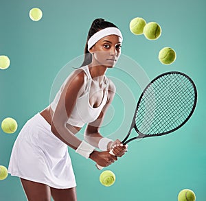 Tennis, sport and training with a young female player holding a racket and hitting balls in studio against a green