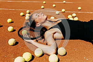 Beautiful girl athlete on the tennis court. Tennis training, racket and ball, concept.