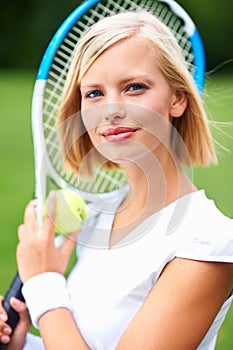 Tennis, woman and portrait with racket, ball and training to play match, contest and competition outdoor. Face of happy