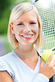 Tennis, woman and smile with racket, ball and training for performance, contest or competition outdoor. Portrait, face