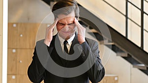 Tense Young Businesman in Office, Headache