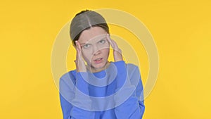 Tense Young Woman with Headache on Yellow Background
