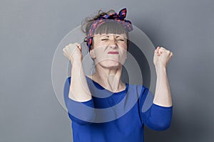 Tensed 30s woman with fifties hairstyle expressing motivation