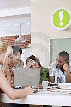 Tensed Business People Using Laptop In Office