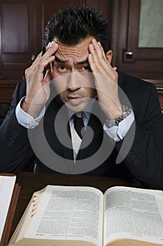 Tensed Male Advocate With Law Book photo