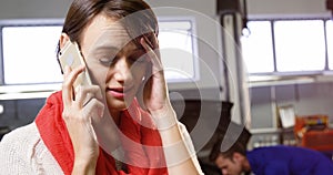 Tensed woman talking on mobile phone