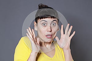 Tensed young brunette woman looking stunned