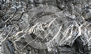 Tension gashes filled by calcite and quartz on a rock boulder photo