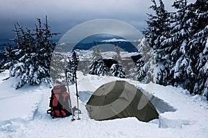 Tent and backpack on the snow
