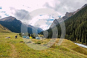 Tent basecamp in mountain river valley