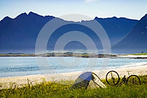 Tent and bike on beach, Lofoten Norway