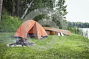 Tent, campfire and canoe on Minnesota lakeshore