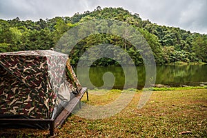 Tent for camping on grass in a hill near river