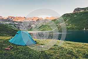 Tent camping at sunset Mountains and lake Landscape Travel Lifestyle