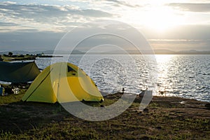 Tent on coast at sunrise