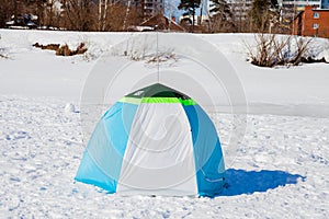 Tent of the fisherman in the winter afternoon on river