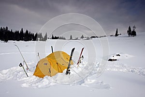 Tent fitted with skis in snow