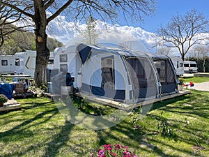 A tent in front of a travel trailer at a campsite, Caravan camping, Relaxing campsite, Trailer park, Summer Camping