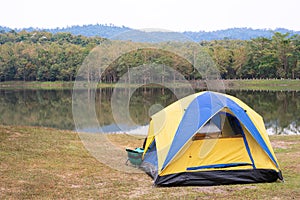 Tent on green grass beside lake