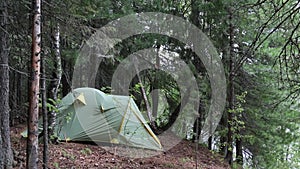 Tent installed on the shore of the Siberian taiga river