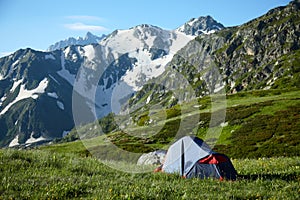 Tent on meadow in the high mountains