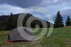 Tent on mountain col in grass in the evening. On background Velky Rozsutec. Mala Fatra mountains, Slovakia