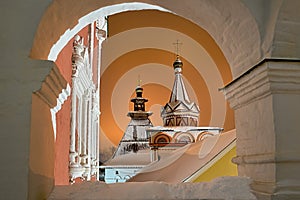 Tent-Roofed Towers Framed by Arch in the Winter Night