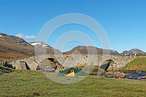 Tent by Spey river at Garva bridge, Scotland in spring