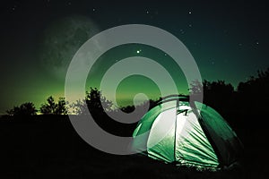 Tent under stars and moon