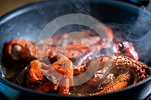 Tentacles of octopus in frying pan